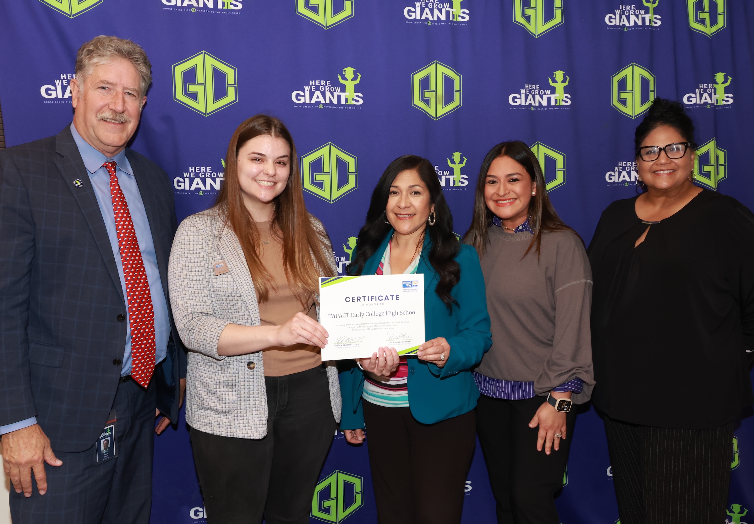united way representatives and district leaders pose with certification