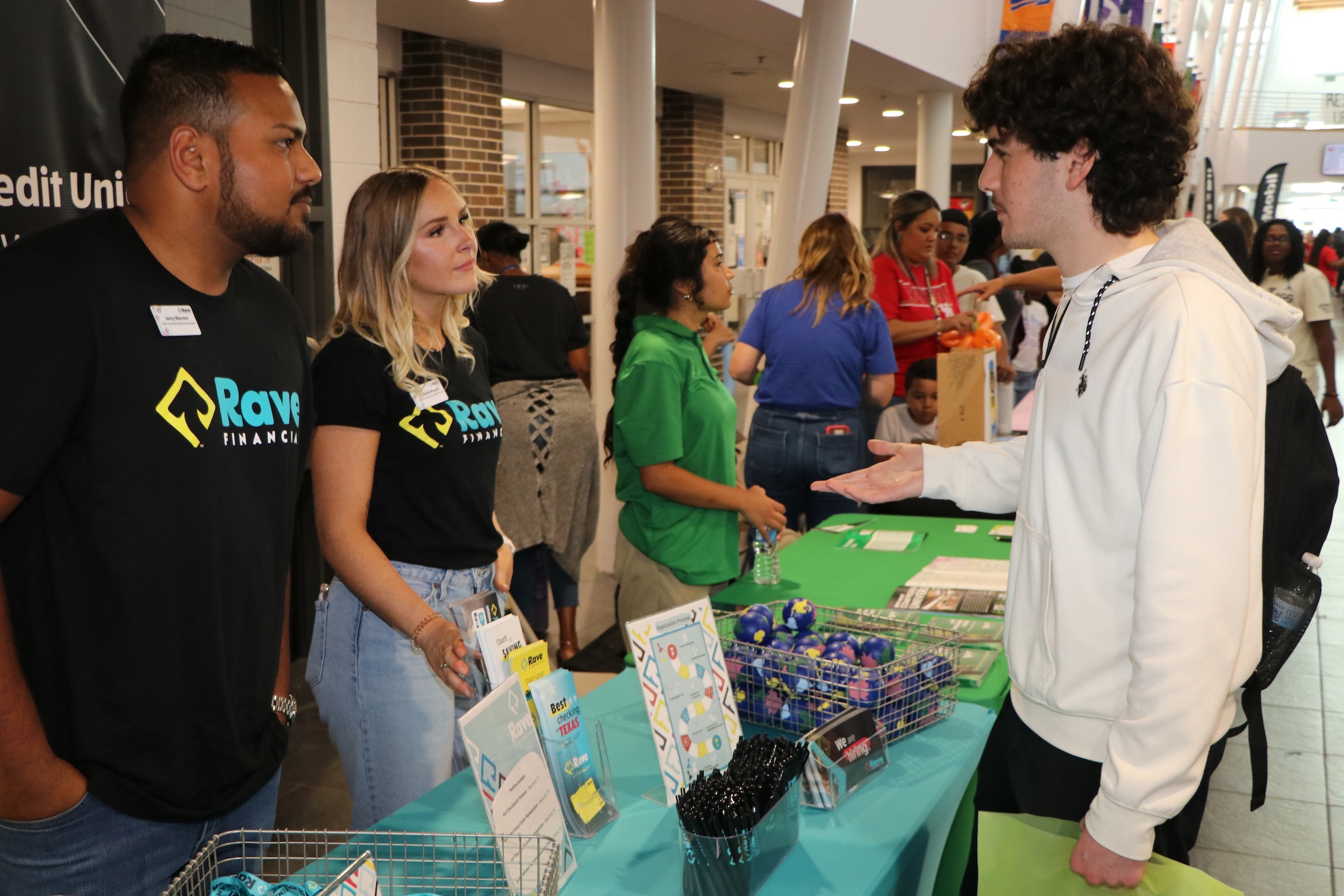 a student speaks with vendors at the college and career fair