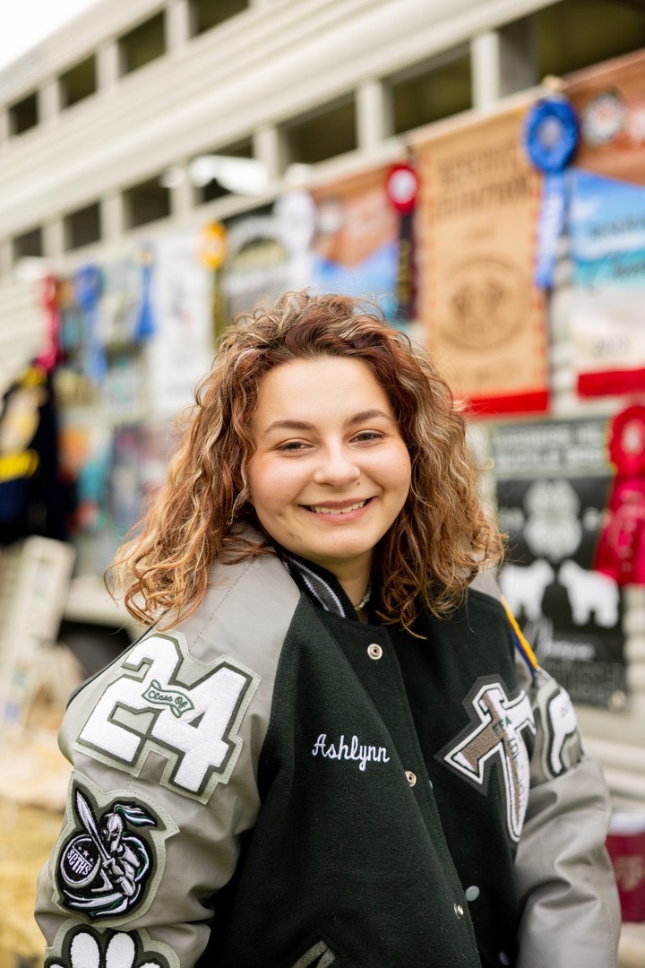 ashlynn mcmakin posing in her stuart career tech letterman jacket