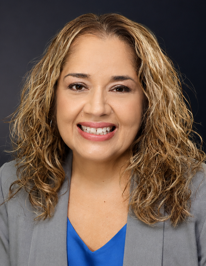 Michelle Jackson smiling wearing a gray blazer and blue shirt