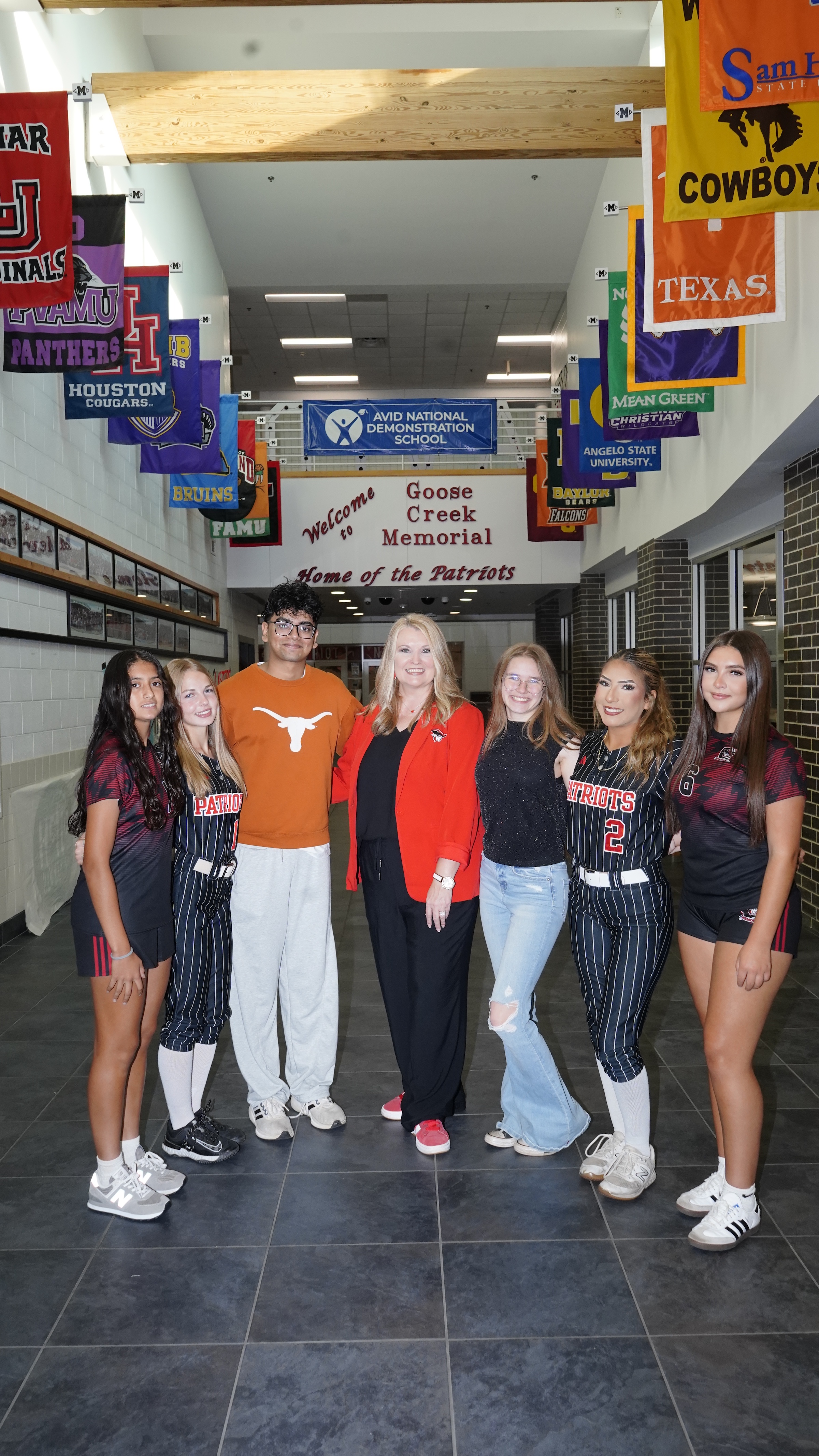 kelley start stands in the school hallway with students