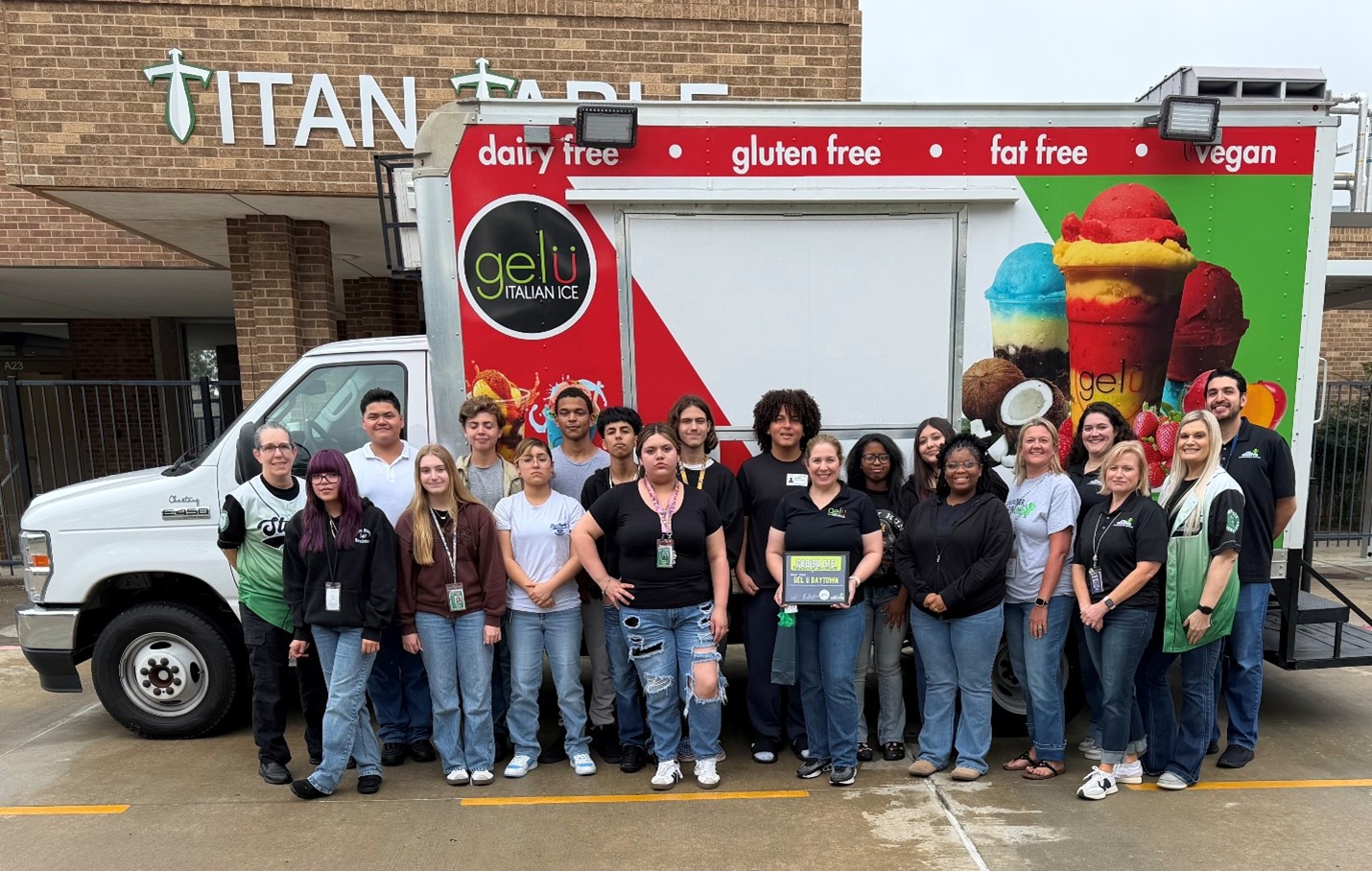 GelU staff with SCTHS stduents in front of the gelu truck holding their certificate