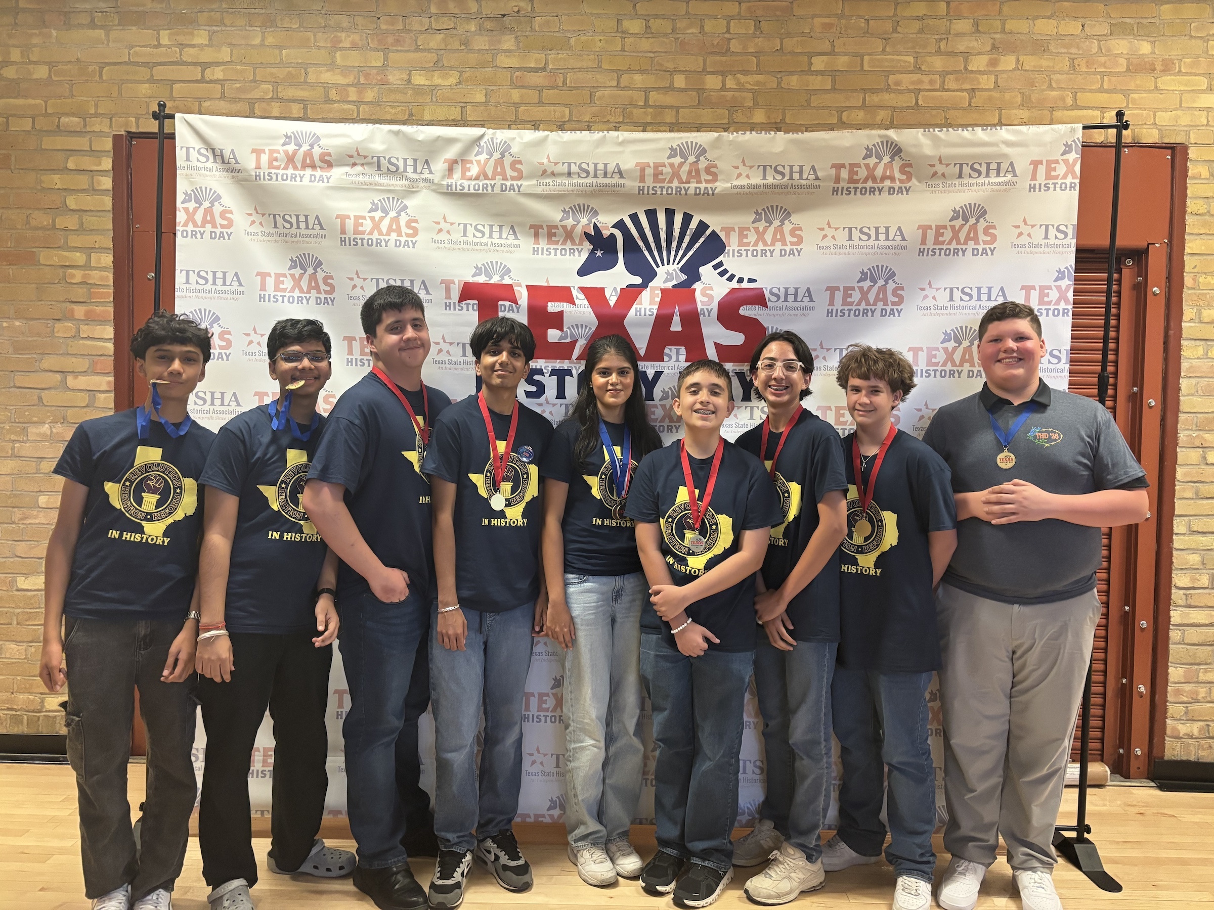 Students standing in front of Texas History Banner