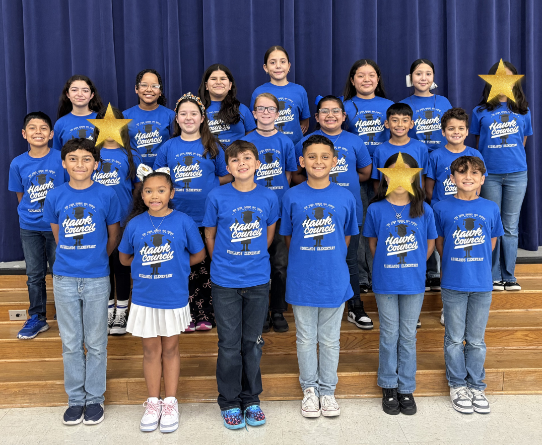 Student council students stand on stage stairs wearing student council shirts