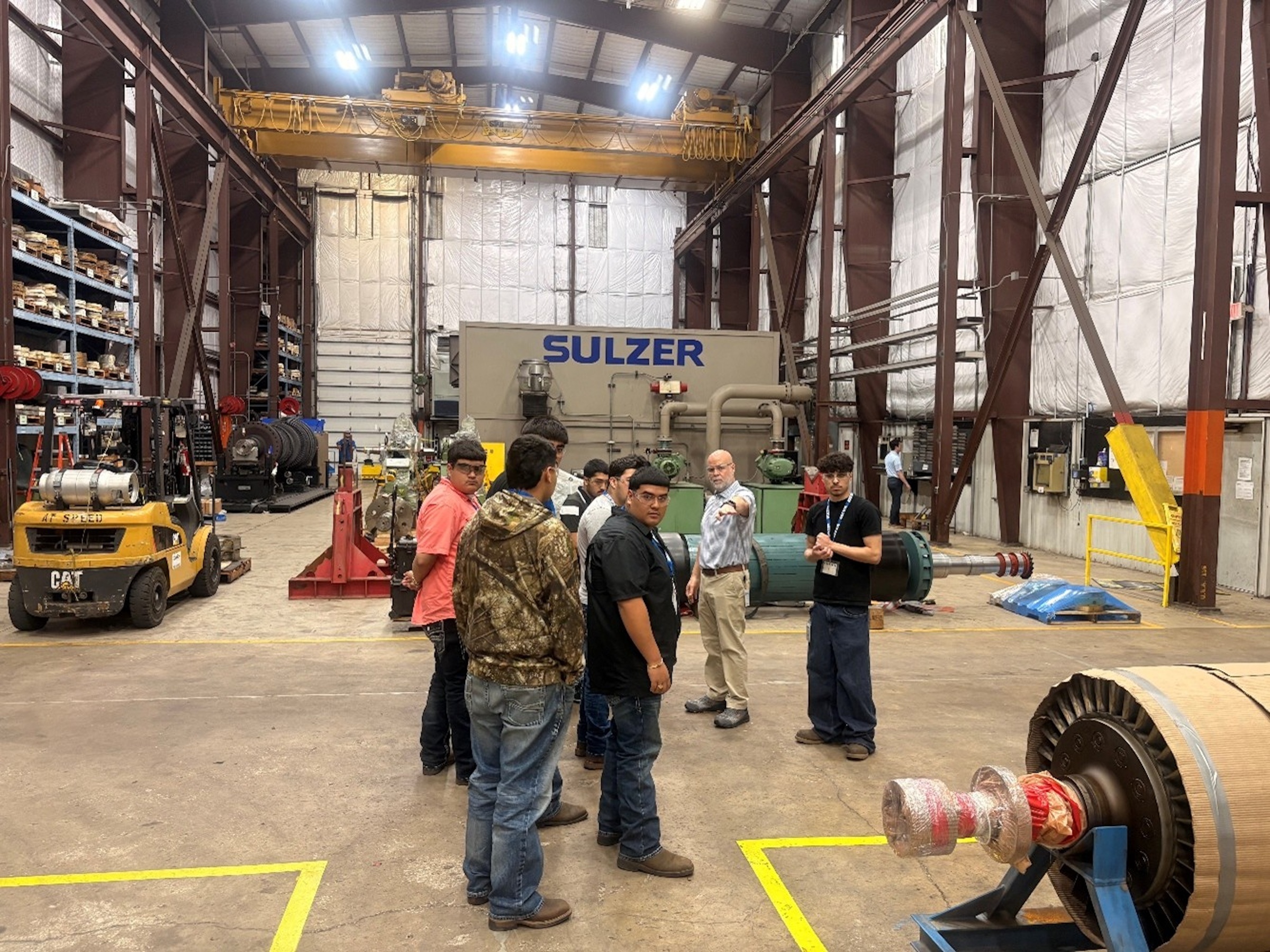 Students with Sulzar Rep in warehouse