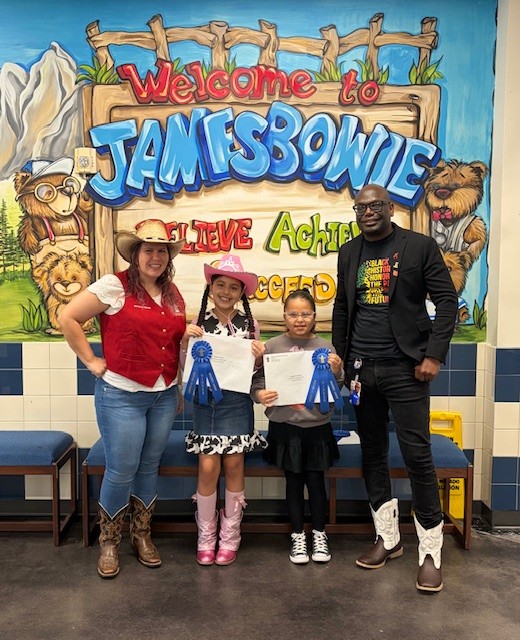 Bowie principal and students pose with awards in school