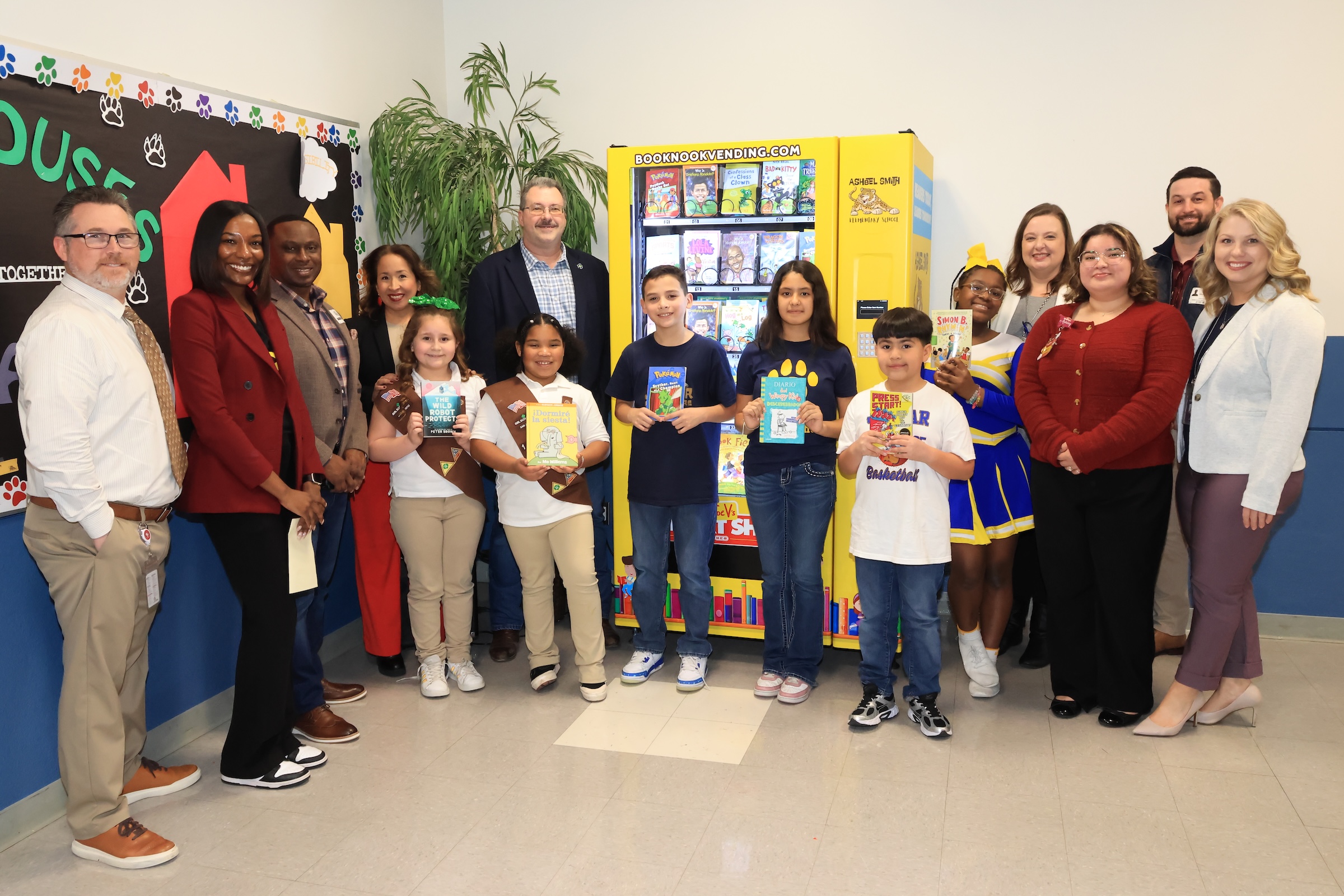 Ashbel elementary students, district leaders, campus leaders and community pose with book vending
