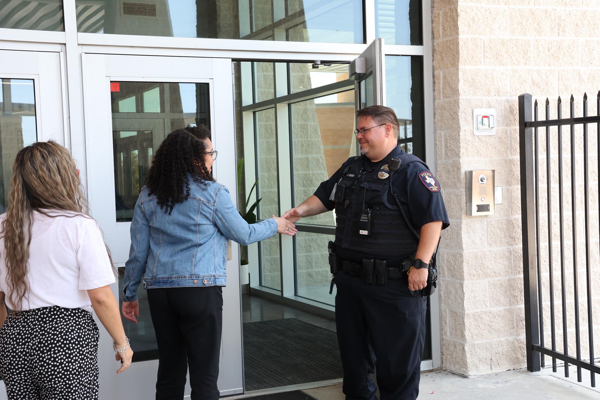 goose creek officer greeting guests at ef green
